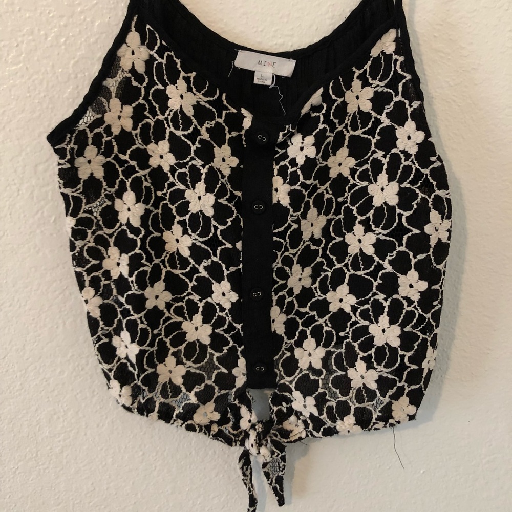 Strappy flower top with tie at the bottom.